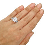 Elegant White Gold Ring with Sparkling Emerald-cut Moissanite and Dazzling Diamond Accent.