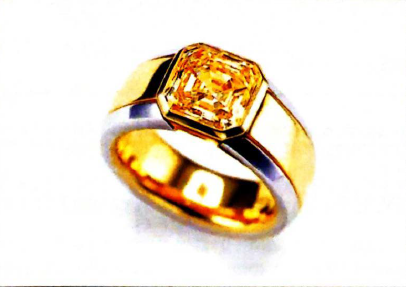  A 3-carat fancy intense yellow radiant cut diamond in a platinum and 18K gold man's ring